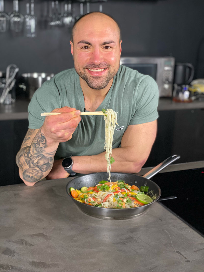 Der Trainer bereitet sich darauf vor, ein Gericht zu essen, das er gerade zubereitet hat.